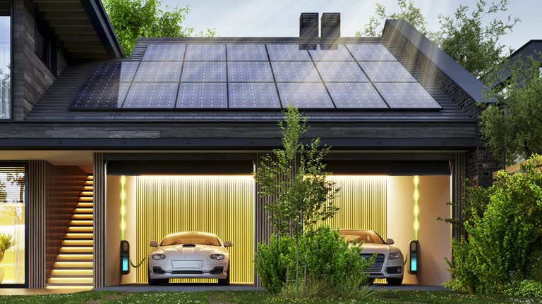 garage avec deux voitures branchées et des panneaux photovoltaiques sur le toit - solest energies - Selestat